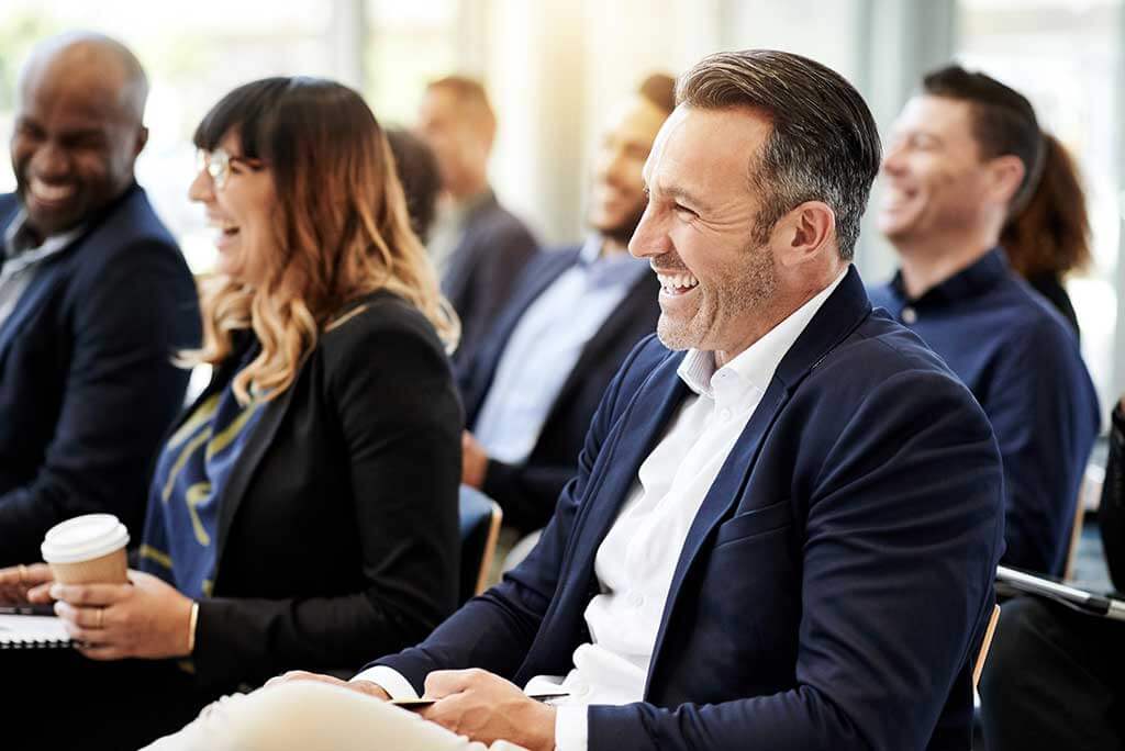 A man with hearing loss at a work event. 