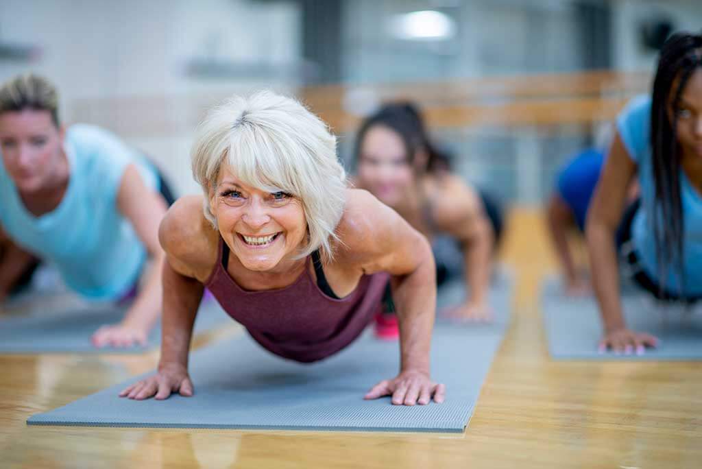 A woman with hearing loss in yoga class. 
